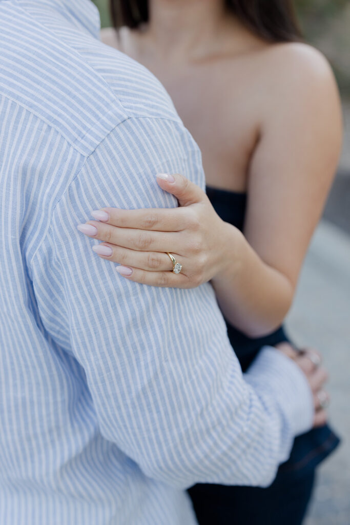 Close-up fine-art detail of a stunning diamond engagement ring during a post-proposal embrace, captured by luxury surprise proposal photographer Ignatios Kourouvasilis. Luxury Surprise Proposal Photographer Ignatios Kourouvasilis